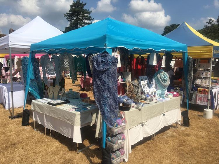 An outside summer craft fair table set up